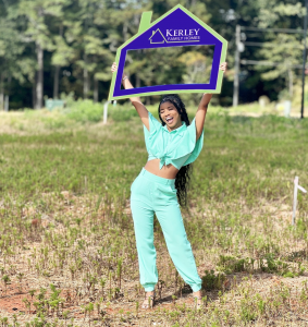 Kerley homeowner holding the KFH sign